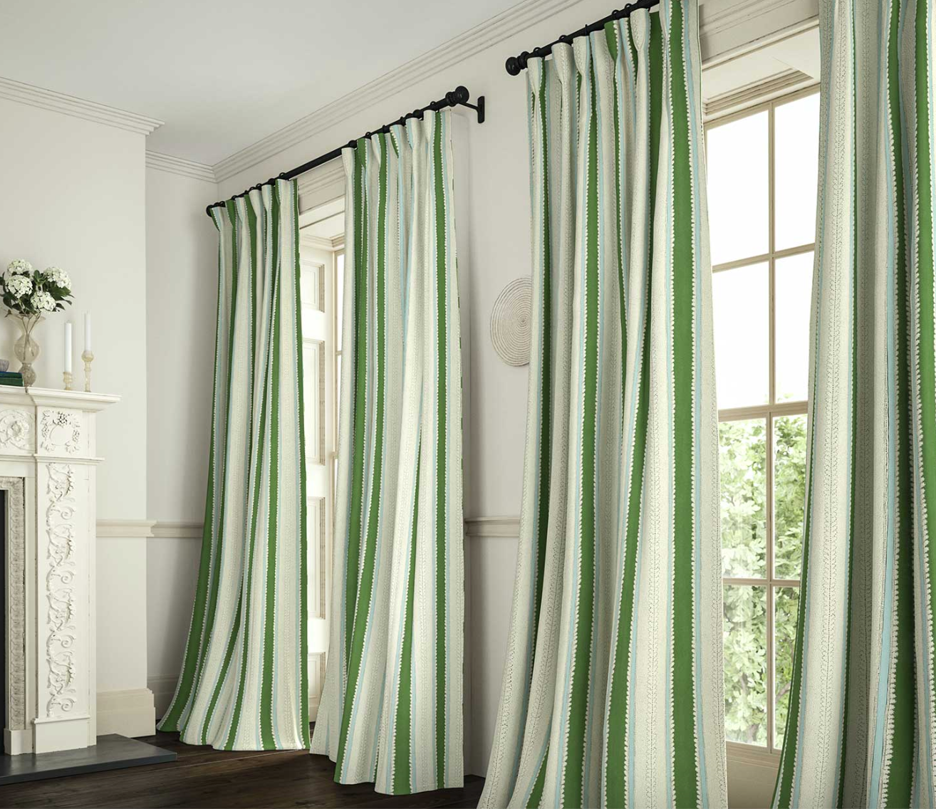 Green and white striped curtains hanging in a room with a fireplace and window.